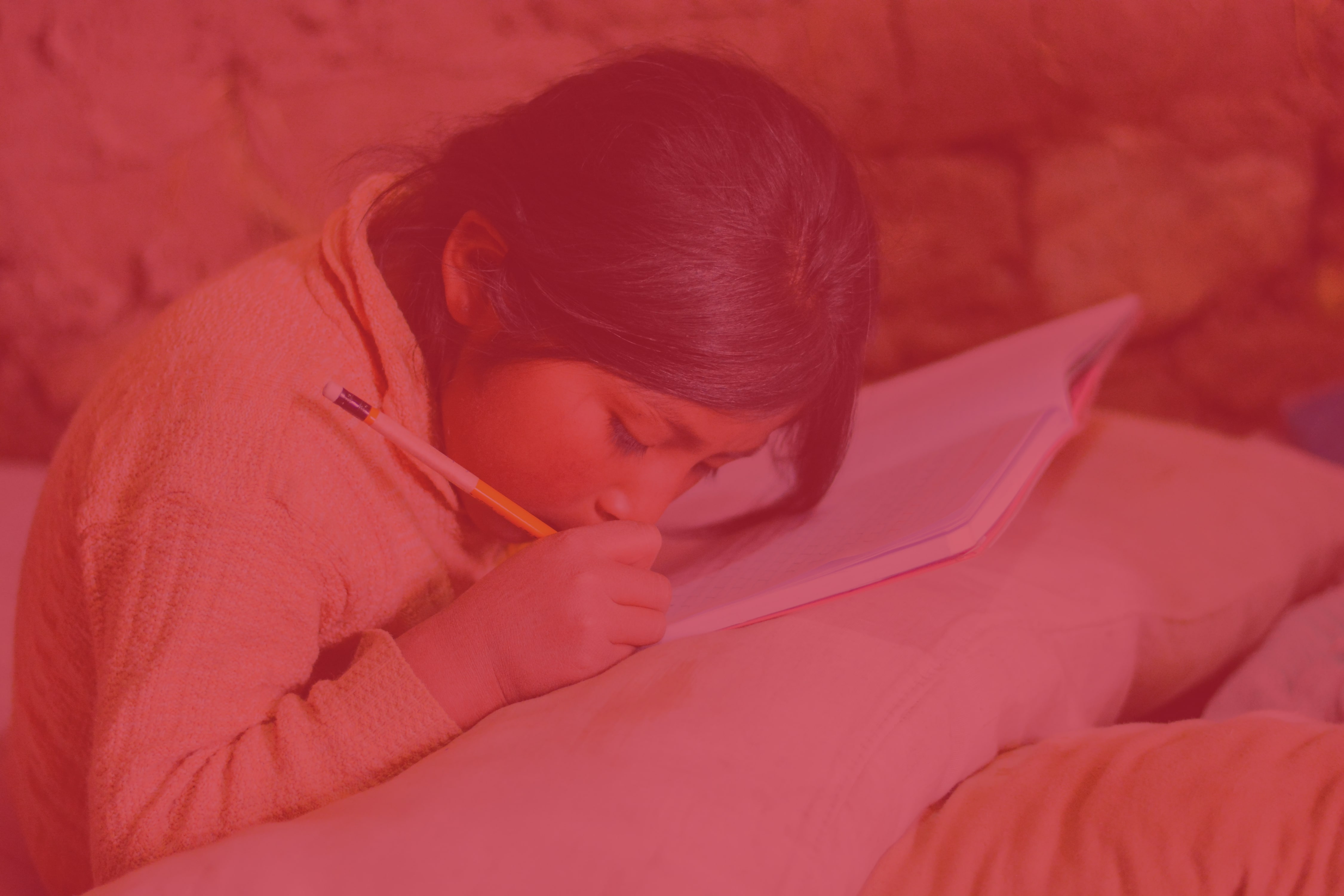 Young girl writes in a book