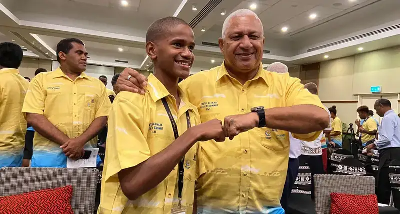 The Prime Minister of Fiji, Josaia Voreqe Bainimarama with youth climate activitist Timothi Nausulasala at the opening of the first Fijian National Youth Climate Action Summit.
