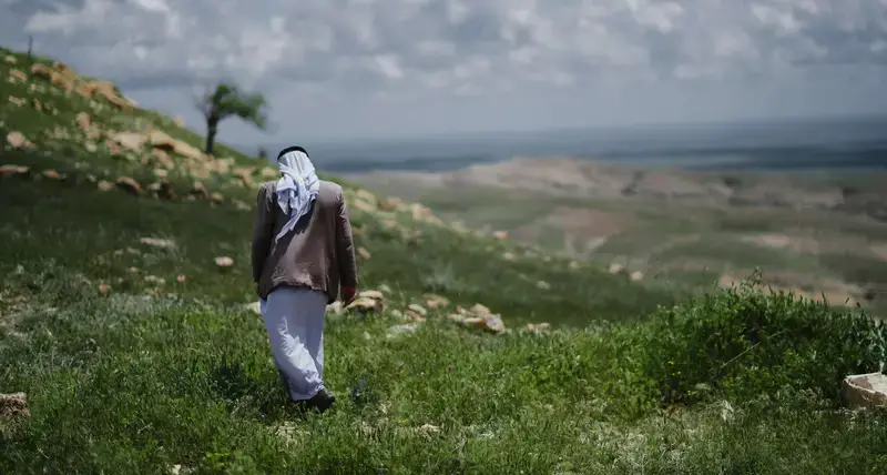 Yazidi man walking near the Mam Rashan Shrine on Mount Sinjar
