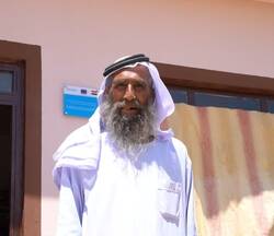 Man standing in front of his newly received house